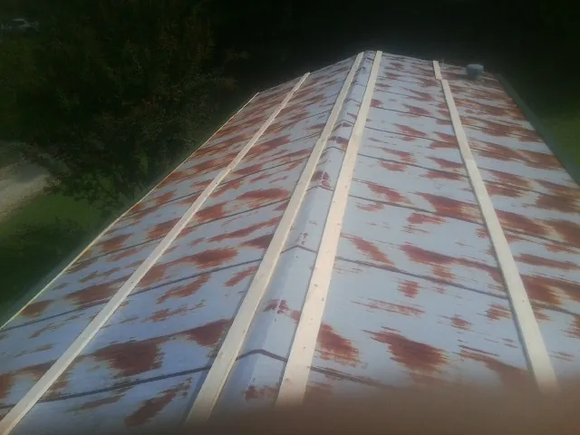 Rusted metal roof panels with new wood purlins before replacement — Storm Damage Roof Repair in Sutherland Springs by Roofing Brothers